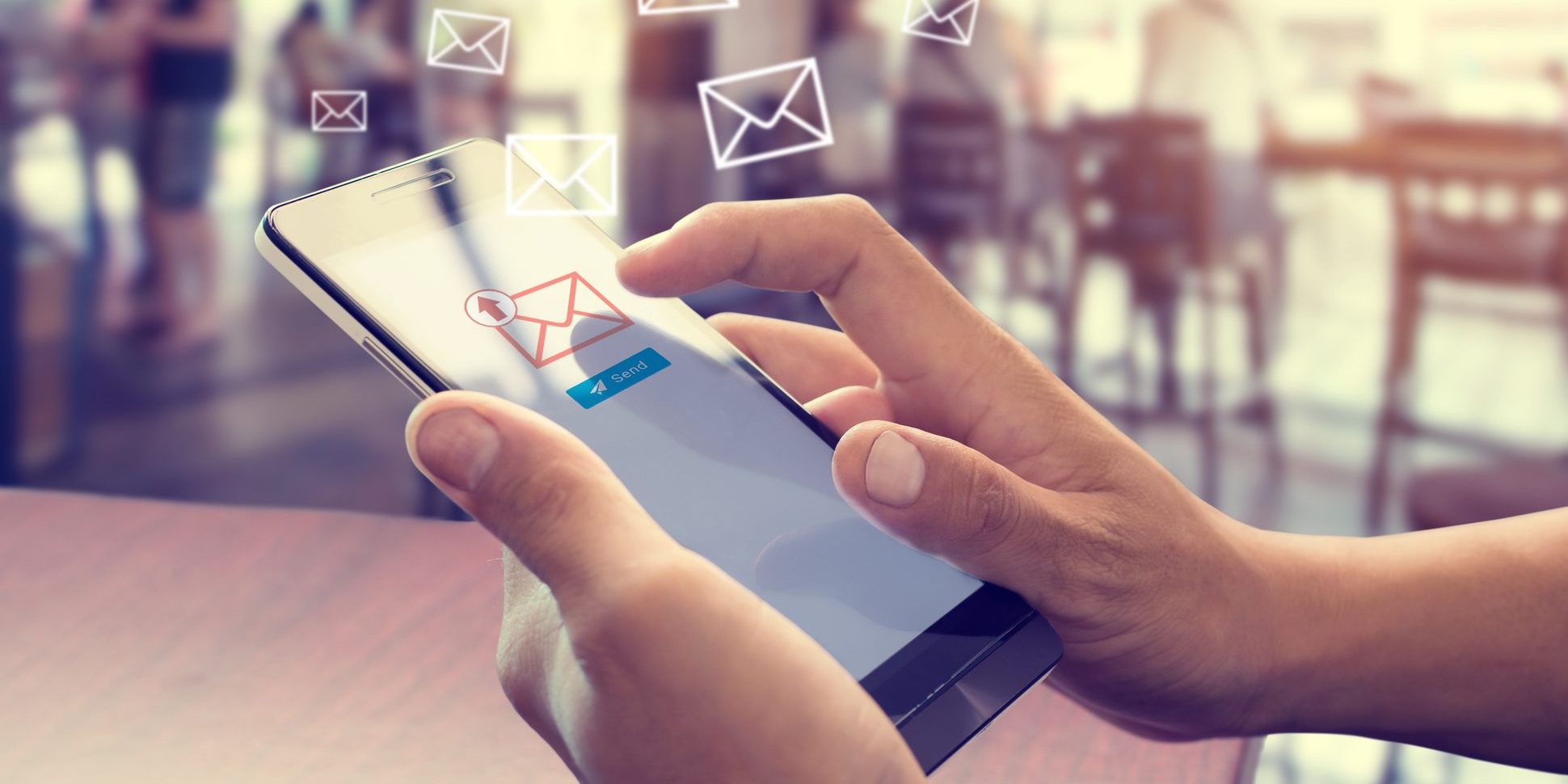 Hand of male using mobile phone to sending E-mail message with email symbol and envelope icon. Email marketing concept